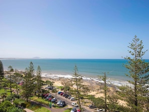 A coastal view with a parking area, beach, and clear sky. - Mantra Zanzibar Mooloolaba (Sunshine Coast)