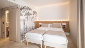 A double bed with a headboard, bedside tables, and a wall mural. - Hotel le Relais des Brasseurs (Aubagne)