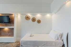 A hotel room with a bed, a flat-screen TV mounted on a wall, and three woven wall art pieces. - Pontikonissi Adults Only (Corfu)