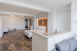A modern hotel room with a large bed, a desk, and a seating area. - Pontikonissi Adults Only (Corfu)