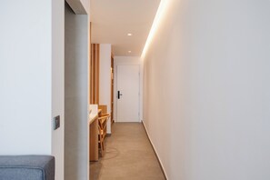 A narrow hallway with a wooden bench and a door at the end. - Pontikonissi Adults Only (Corfu)