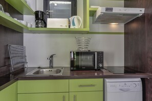 A compact kitchen with a sink, a coffee maker, a microwave, and a dishwasher. - La Grande Motte "Le Ponant" (La Grande-Motte)