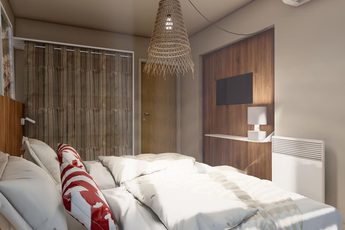 A modern bedroom with a bed, a hanging light fixture, a television, and a bedside table.