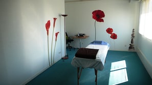 A room with a bed, a desk, a chair, and a window.
