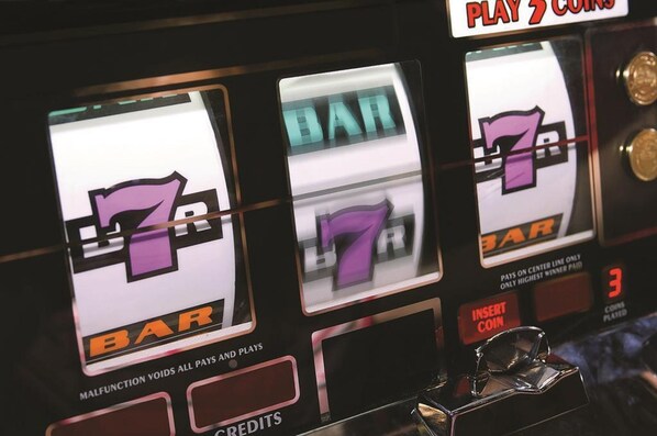 A slot machine with the number 7 displayed on its screen, a coin slot, and a button labeled 'INSERT COIN'. - Caesars Southern Indiana Hotel Casino (Elizabeth)