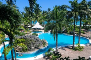 A resort with multiple swimming pools, palm trees, and a beach area. - Diani Reef Beach Resort & Spa (Diani Beach)