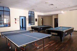 A room with a ping pong table, two pool tables, and a fire extinguisher. - Diani Reef Beach Resort & Spa (Diani Beach)