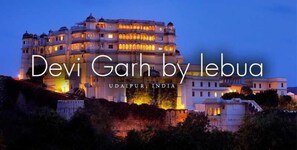 A large, multi-story building with traditional architecture, located in Udaipur, India. - Raas Devigarh, Udaipur (Nathdwara)