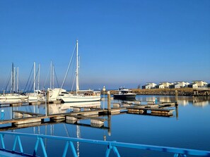 A marina with boats docked, calm water, and a row of buildings in the background. - RBR 312 - Beach Resort Kamperland by Interhome (Kamperland)