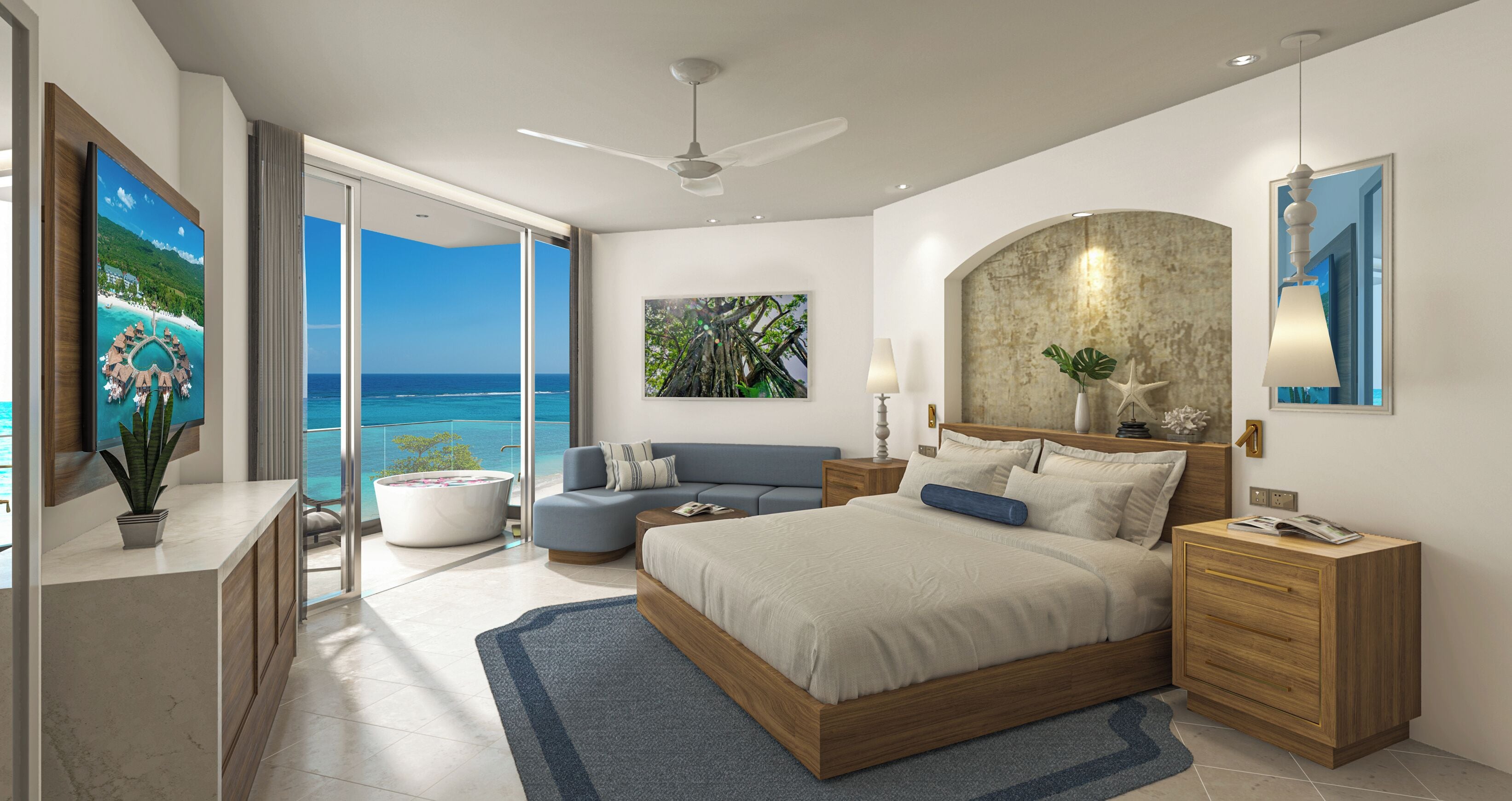 A modern bedroom with a large bed, a sofa, a desk, and a view of the ocean.