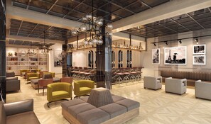 A spacious lobby with a high ceiling, a central bar area, and seating arrangements. - Sandals Dunn's River Falls (Ocho Rios)