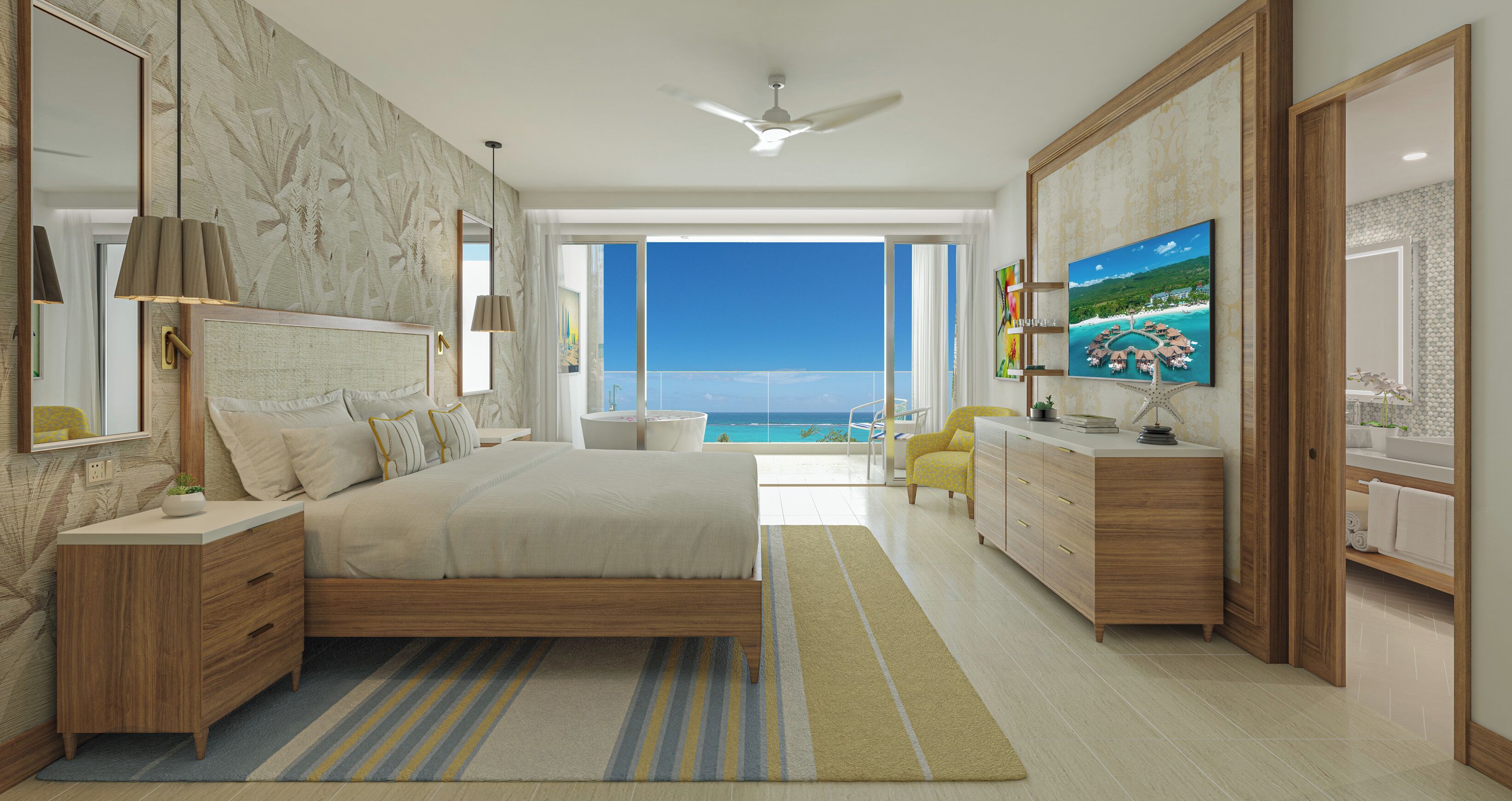 A modern bedroom with a large bed, a TV, a dresser, and a view of the ocean.