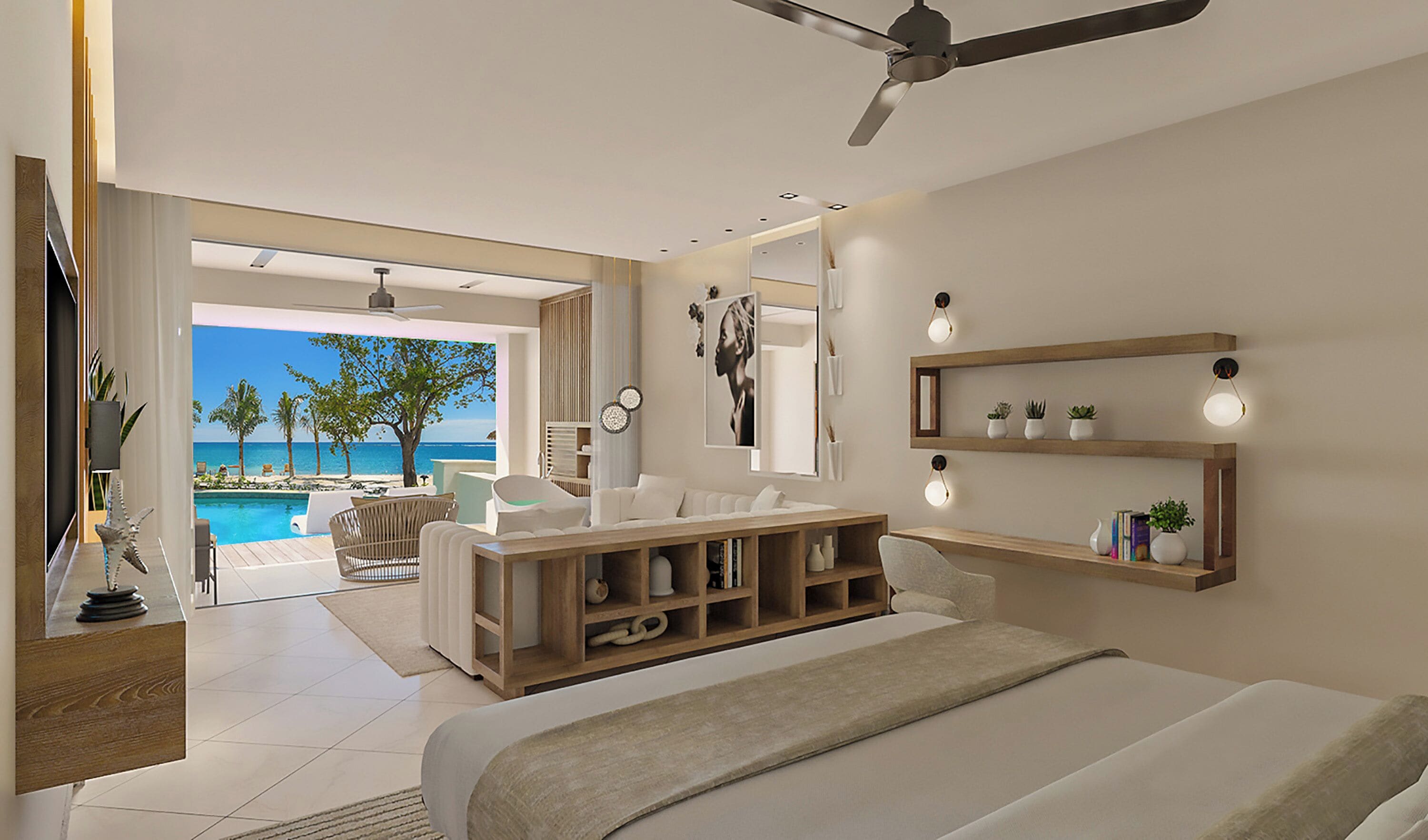A modern bedroom with a large bed, a ceiling fan, a wooden nightstand, a bedside table with a lamp, a large mirror, and a view of a pool and beach.