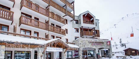 Un hotel de varios pisos con balcones, fachada de piedra y un letrero que dice 'Le Borsat IV'.