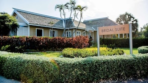 A building labeled 'BRIDAL SUITE' with a well-maintained garden and a clear sky.