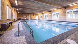 An indoor swimming pool with wooden walls and benches. - Econo Lodge Vernon Area (Vernon)