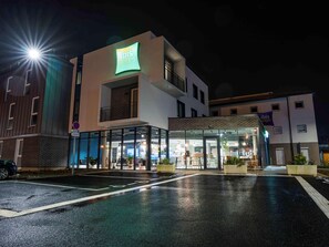 A modern hotel with a glass facade, a prominent 'ibis Styles' sign, and a visible entrance. - Ibis Budget Le Treport Mers les Bains (Mers-les-Bains)