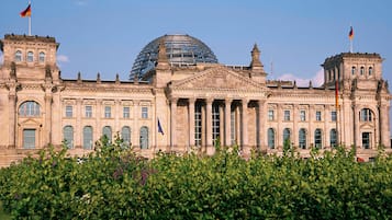 A historic building with classical architecture, featuring a central dome and symmetrical wings.