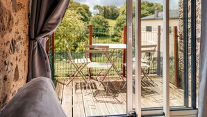 A room with a sliding glass door leading to an outdoor deck with a table and chairs. - Gorgeous home in Sevremont with WiFi (Sevremont)