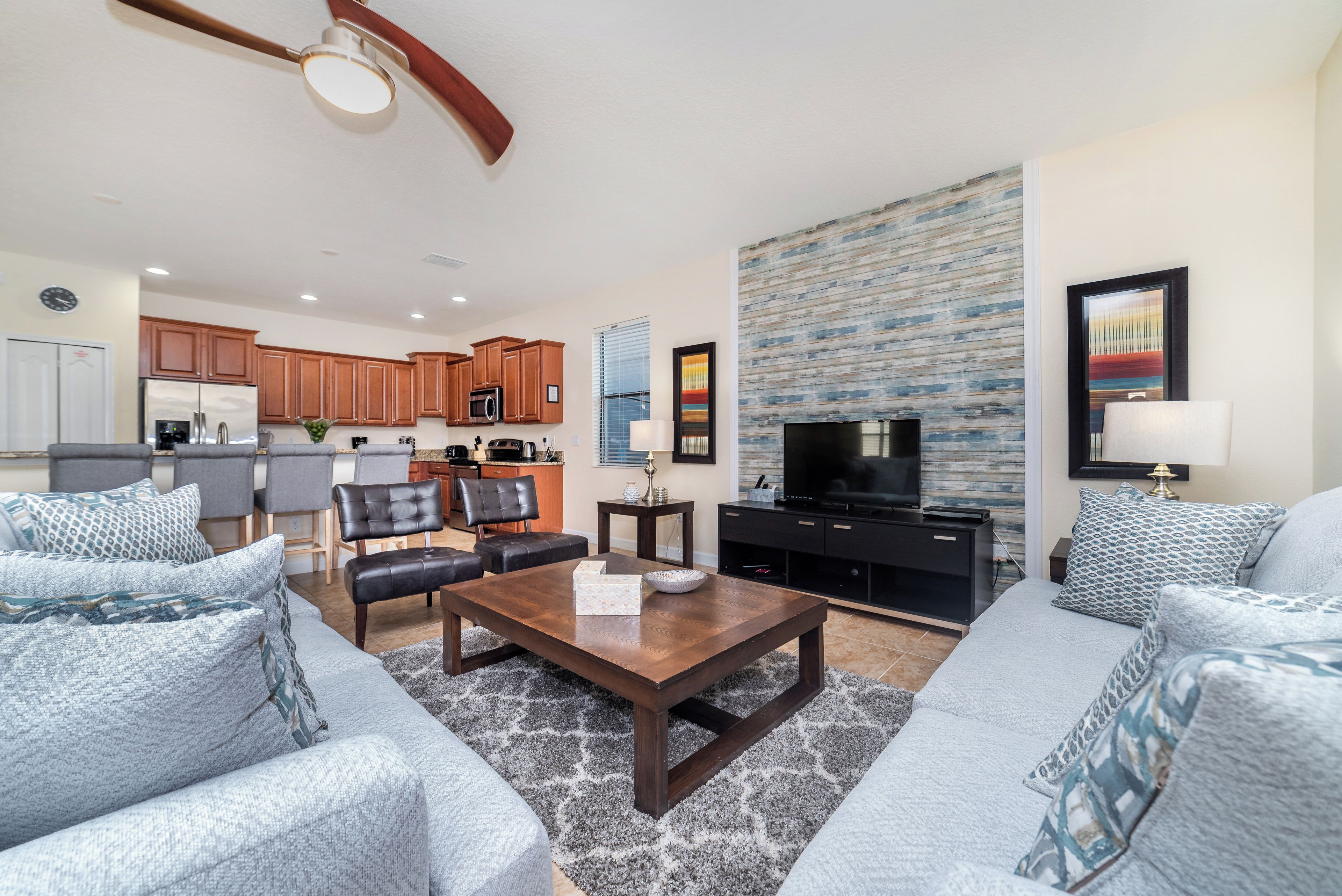 A modern living room with a sofa set, a coffee table, and a television.
