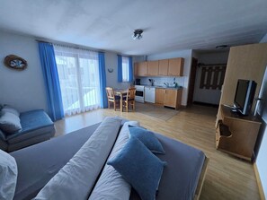 A compact living space with a kitchenette, a dining area, and a seating area with a sofa and chairs. - Haus Rupicapra, (Samnaun-Compatsch) by Interhome (Samnaun)