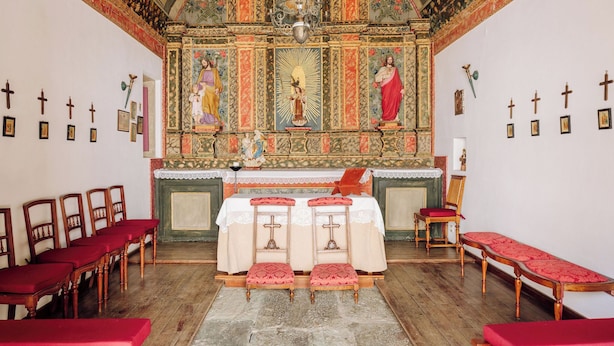 A church interior with ornate ceiling, altar, pews, and religious icons. - Quinta Nova Winery House Relais & Châteaux (Santa Maria da Feira)