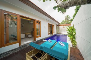 A poolside area with lounge chairs and a small pool. - Three Brothers Bungalows and Villas (Legian)