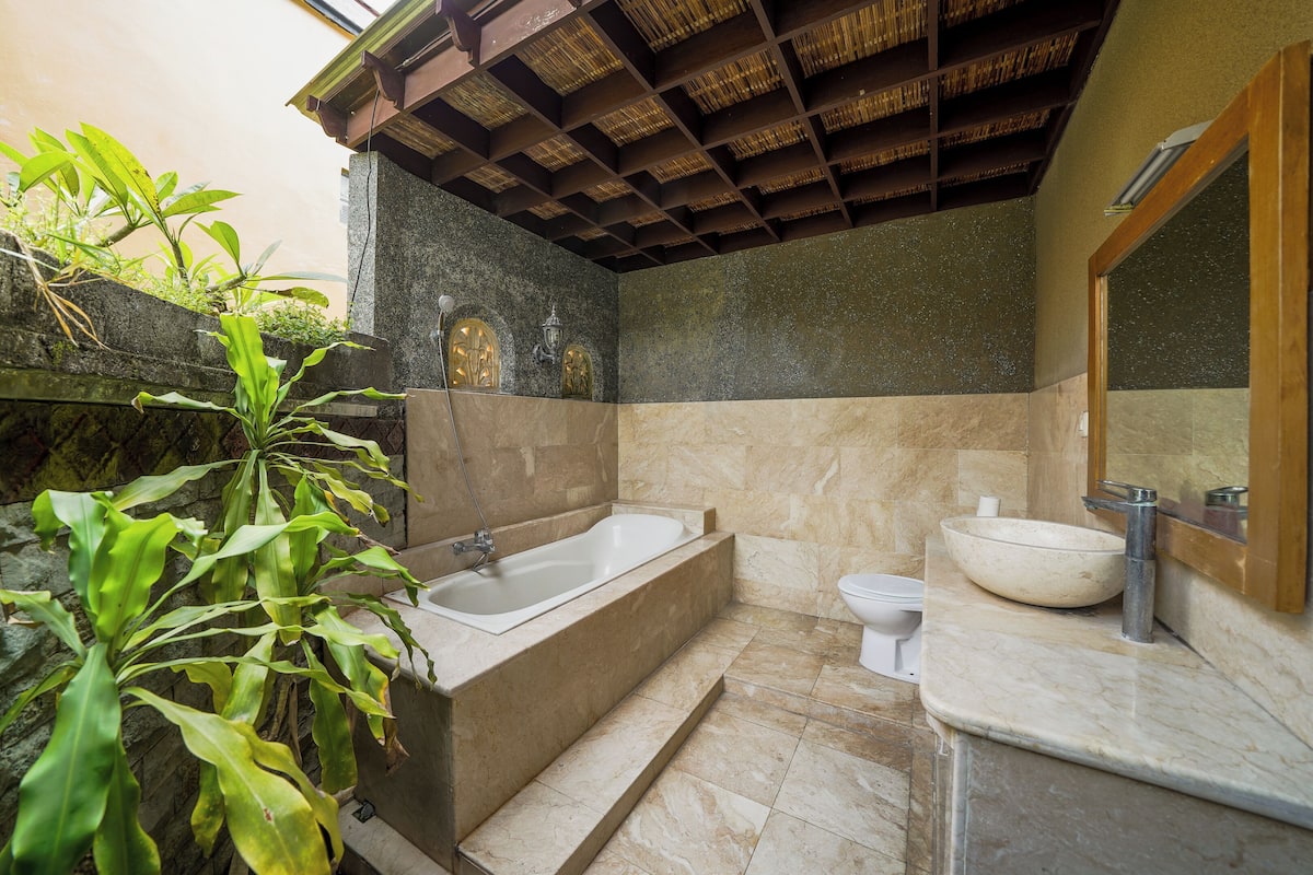 A bathroom with a bathtub, a sink, and a toilet.