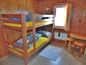 A bunk bed room with a desk and two stools. - Tschlin Chasa La Resgia, (Tschlin) by Interhome (Tschlin)