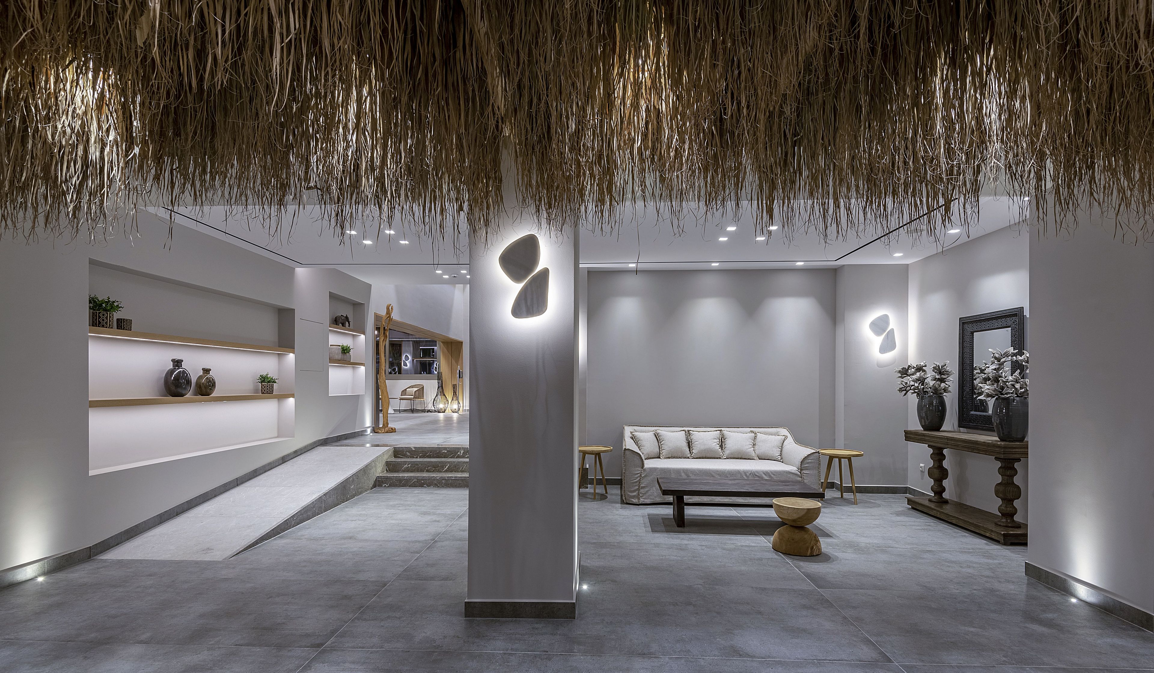 A modern interior with a minimalist design, featuring a sofa, a coffee table, and a decorative wall piece.
