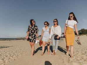 A sandy beach with four people walking. - RBR 711 - Beach Resort Kamperland by Interhome (Kamperland)