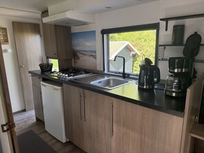 A compact kitchen with a gas stove, sink, and modern appliances. - RBR 168 - Beach Resort Kamperland by Interhome (Kamperland)