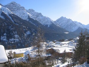 A snow-covered mountain village with buildings and houses. - Via Sura 577A, (Sent) by Interhome (Sent)