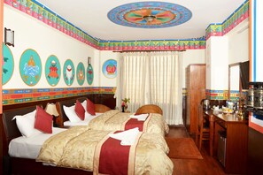 A hotel room with a large bed, a desk with a kettle, and a mirror. - Kathmandu Eco (Kathmandu)
