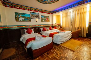 A hotel room with two beds, wooden flooring, and decorative wall art. - Kathmandu Eco (Kathmandu)