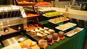 A buffet with various food items, including sandwiches, fruits, and condiments. - The Leaf Boutique Hotel (Da Nang)