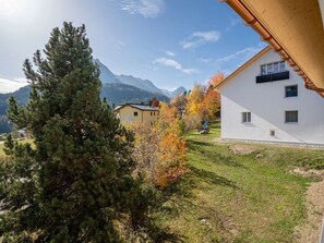 A residential area with houses, a grassy lawn, and a mountain backdrop. - FURTÜNADA, (Scuol) by Interhome (Scuol)