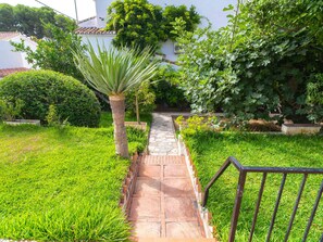 A garden pathway leading to a white building with a tiled roof. - Villa Francisca by Casasol by Interhome (Nerja)