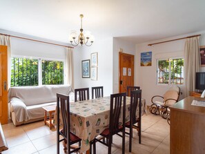 A dining area with a table set for four, surrounded by wooden chairs. - Villa Francisca by Casasol by Interhome (Nerja)