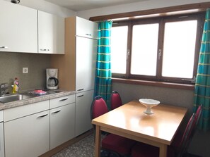 Fridge, oven, cookware/dishes/utensils - Ferienwohnungen Chasa Valär, (Scuol). by Interhome (Scuol)