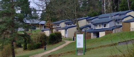 A row of two-story buildings with a sign indicating a VVIP Village.