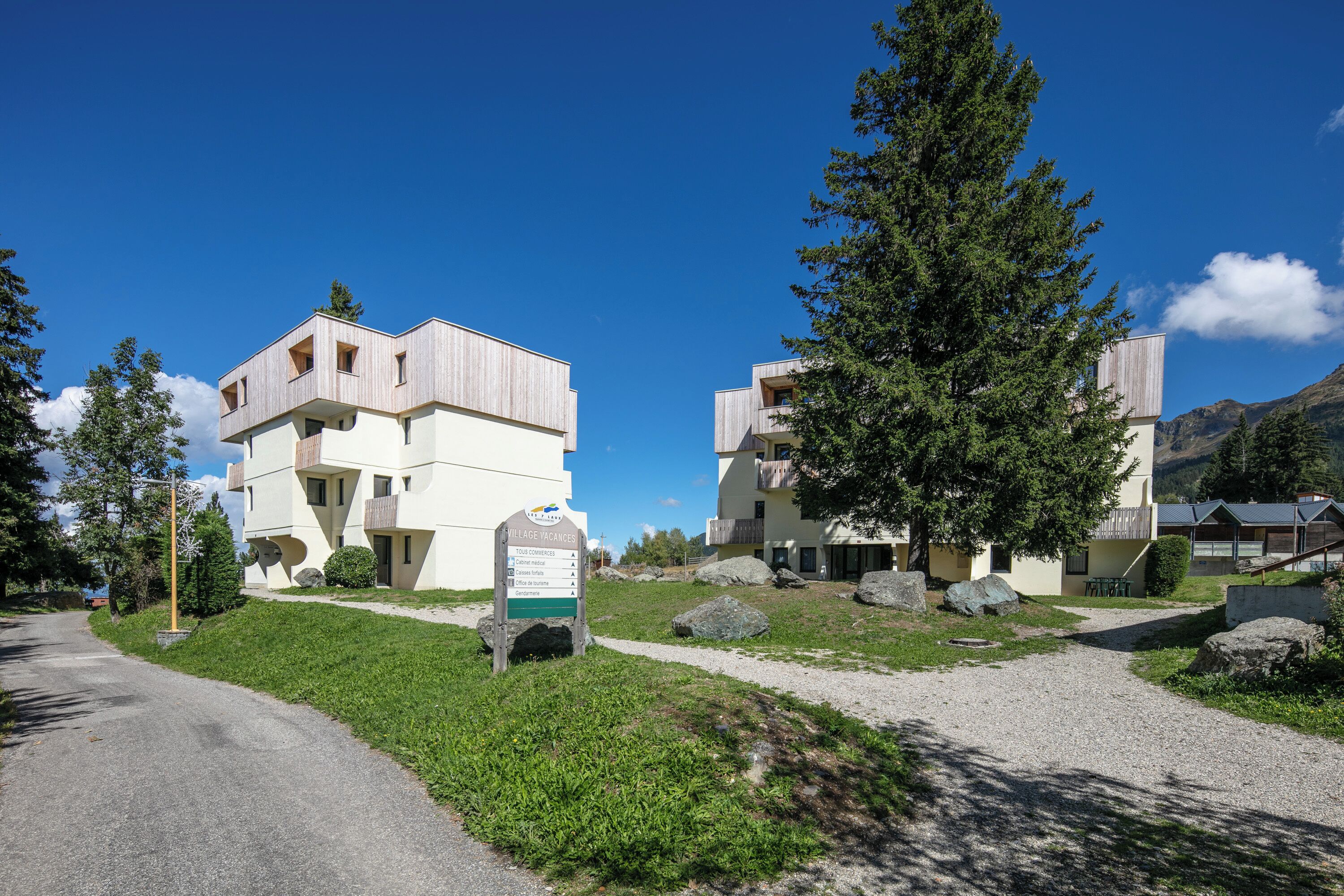A modern building with a sign indicating it is a village accommodation.