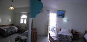 A room with two beds, a wooden bench, a table, and a painting on the wall. - Vossos (Zakynthos)