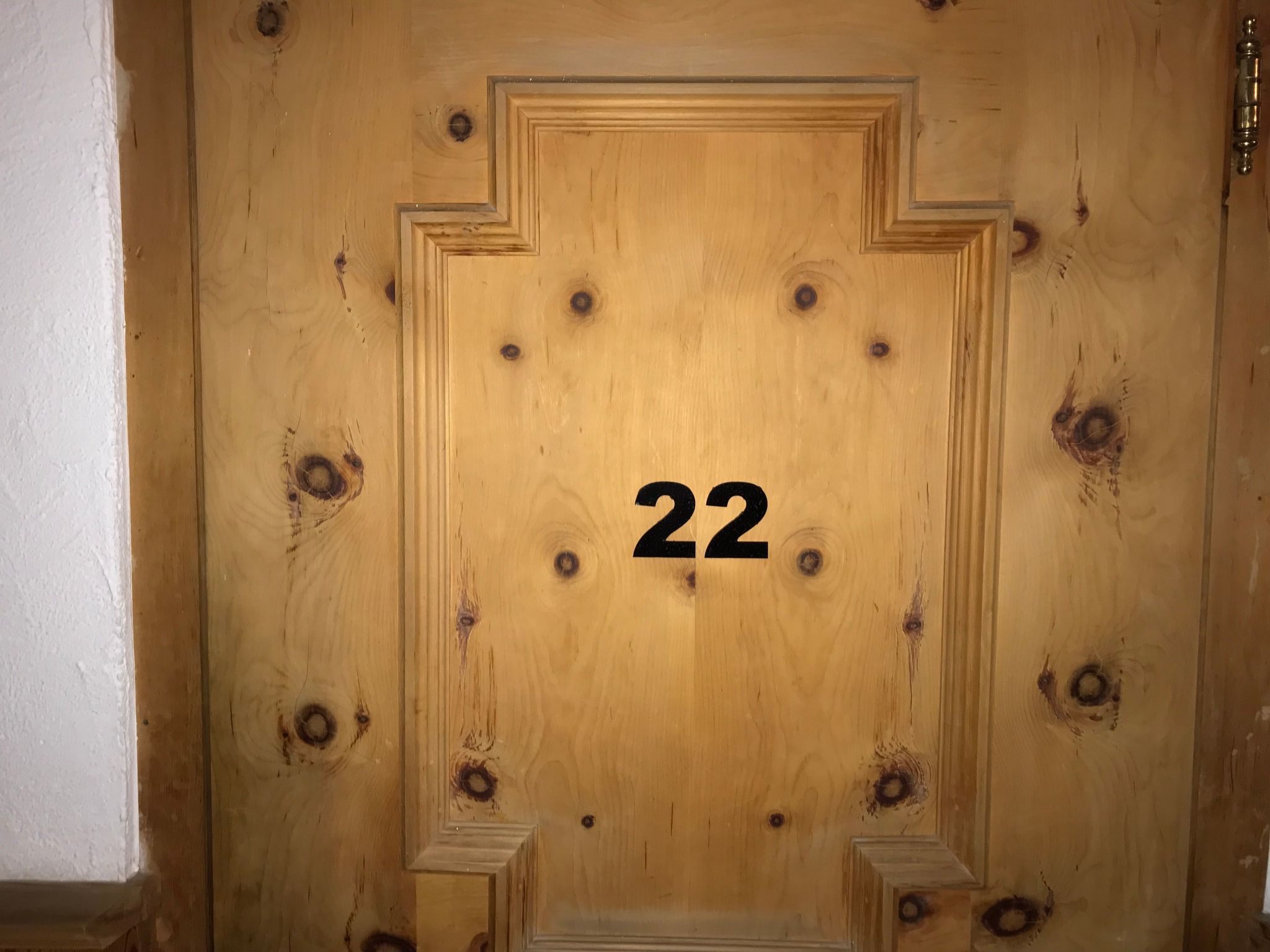 A wooden door with the number 22, indicating a room or apartment number.