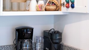 A kitchen area with a coffee maker, a cabinet with glassware, and a basket with utensils. - 3-bedroom house in fabulous Summerton next to lake (Summerton)