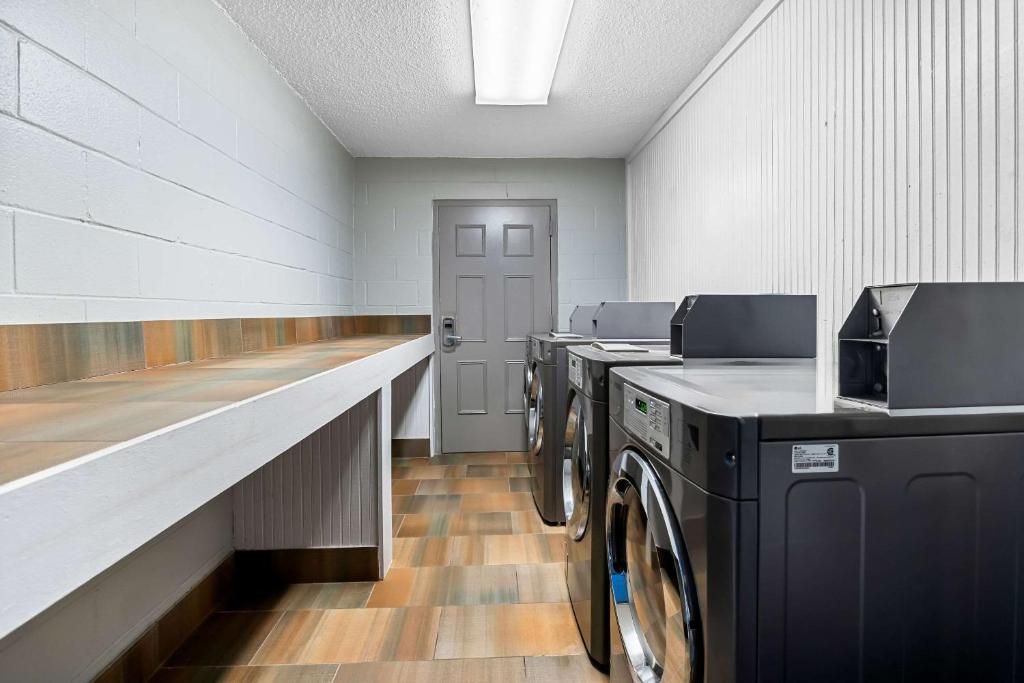 A laundry room with a countertop, a washing machine, and a dryer.
