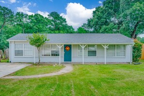 A single-story building with a front door, a small tree, and a clear sky. - Dog River Waterfront Retreat w/ Dock, Boat Lift & Gulf Access (Mobile)