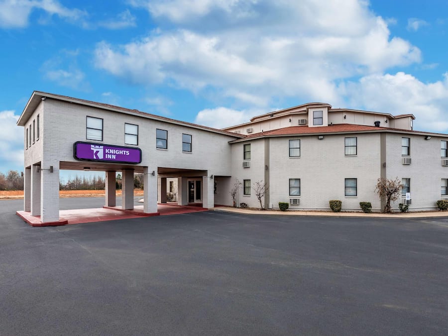 A Knights Inn hotel with a two-story structure, a covered entrance, and a parking lot.
