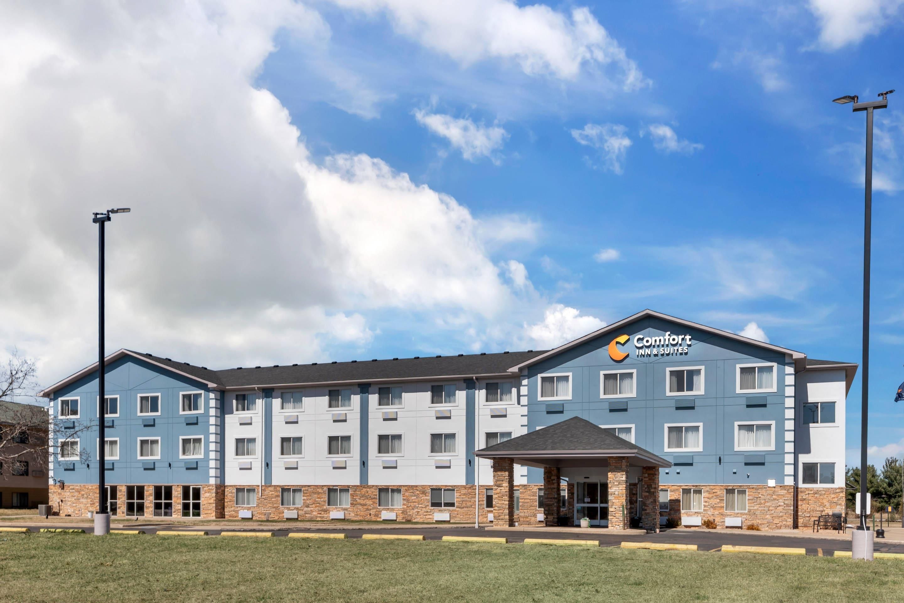 A Comfort Inn & Suites hotel with a two-story building, a covered entrance, and a parking lot.