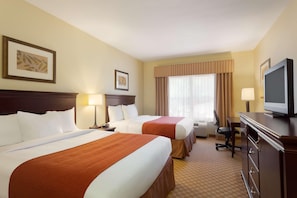 A hotel room with two beds, a television, a desk, and a chair. - Country Inn & Suites by Radisson, Pineville, LA (Pineville)